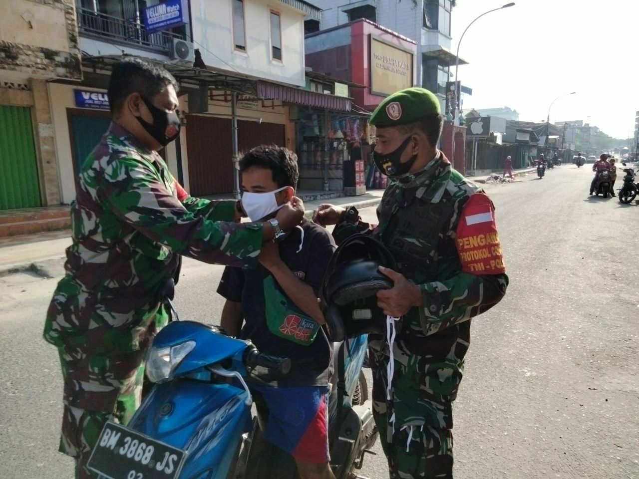 Jumat Berkah, Babinsa Bagi-bagi Masker di Kelurahan Kota Tinggi 