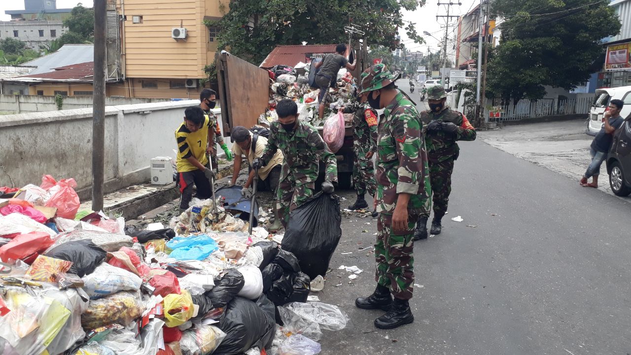 Babinsa Kelurahan Simpang Empat Bersihkan  dan Angkut Sampah di Jalan Zainal Abidin 